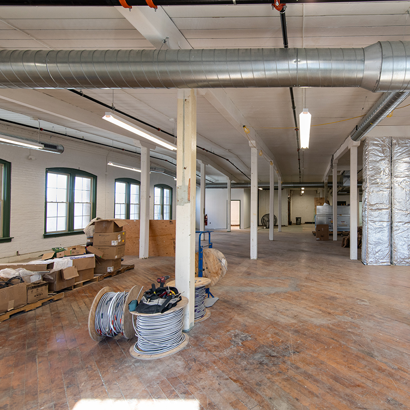 Interior view of 558 River Street; Hardwood floors, columns and arched windows.