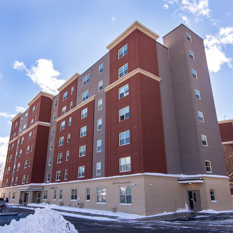 Front view of 558 River Street; a brick two-story building with arched windows.