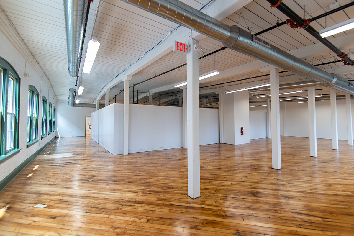 Second floor of Bargain Grocery with large retail freezers and storage.