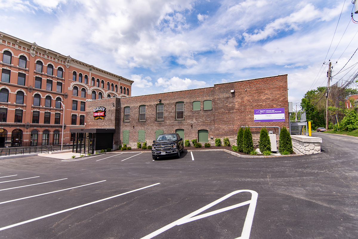 Exterior of Bargain Grocery with a new vestibule, landscaping and parking lot.