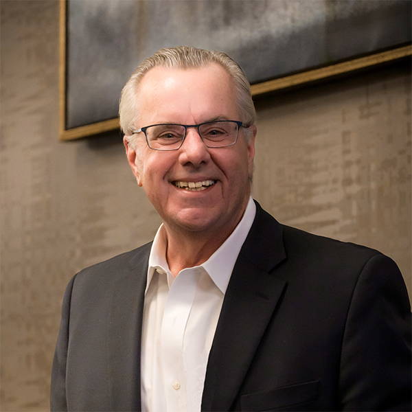 Peter Bette, Member of Bette & Cring, smiling while wearing a black suit.